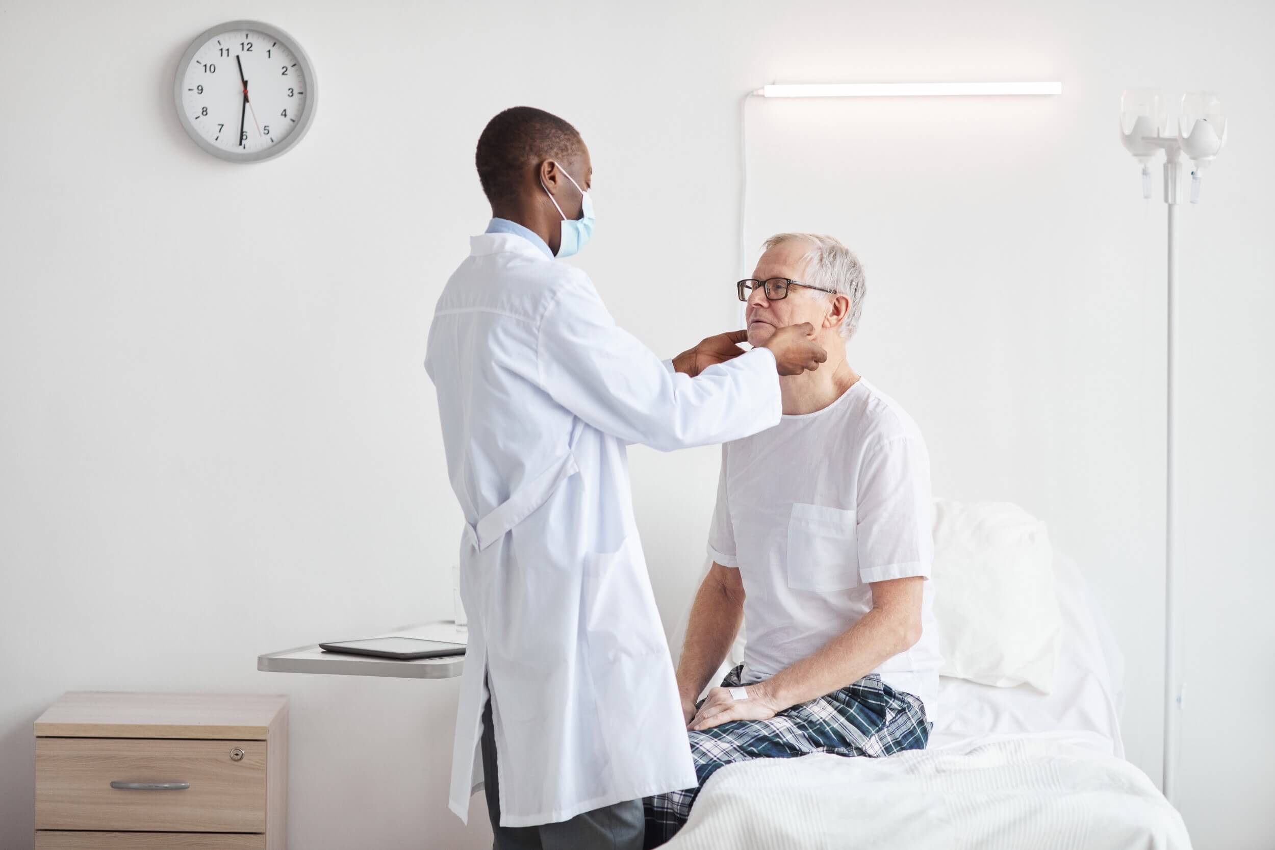 african-doctor-examining-senior-man-in-hospital-2021-09-24-04-17-25-utc.jpg