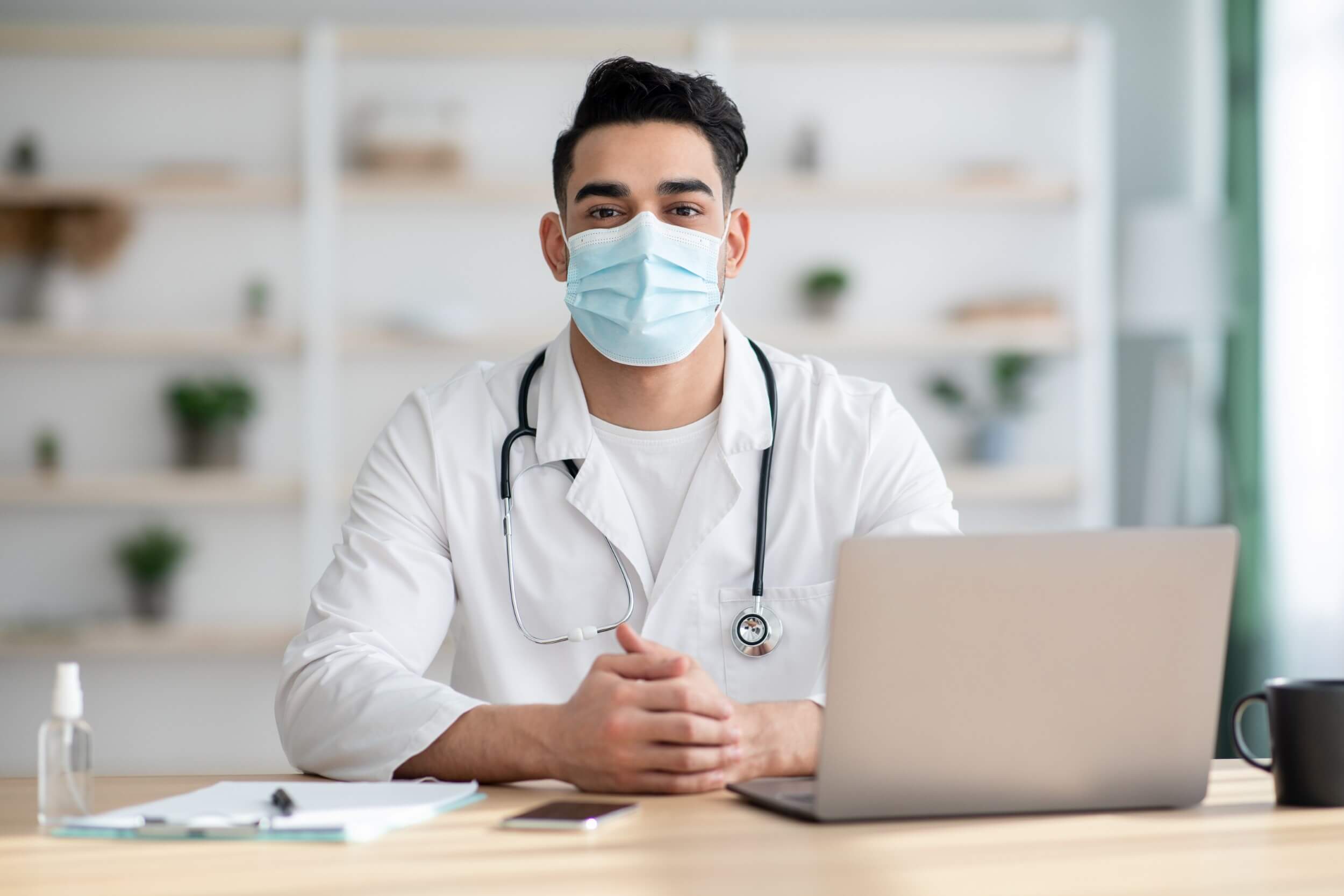 doctor-in-face-mask-working-on-laptop-2021-09-02-17-15-33-utc.jpg